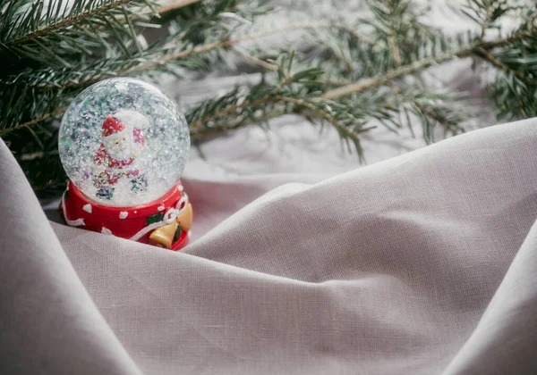 glass snow globe on a light background