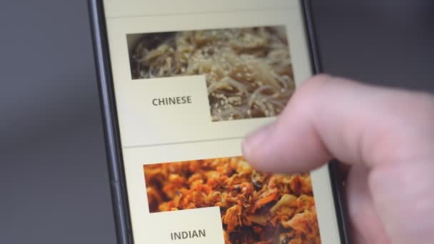 Close up of male hands using smartphone with app delivery asian and mexican food on screen for online order. — Stock Video