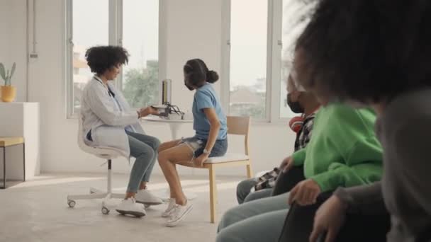 African American Doctor Measuring Blood Pressure Checking Pulse Child Patient — Stok video