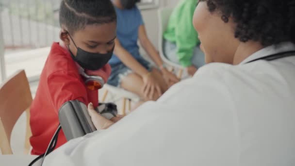African American Doctor Measuring Blood Pressure Checking Pulse Child Patient — Vídeos de Stock