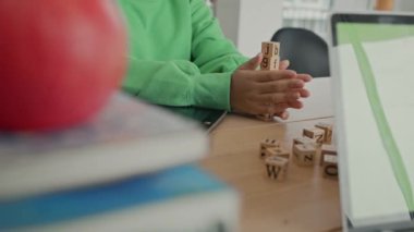 African American student doing activity playing block wooden for development together with enjoy and fun in the classroom.