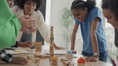 African American teacher and student doing activity playing block wooden for development together with enjoy and fun in the classroom.