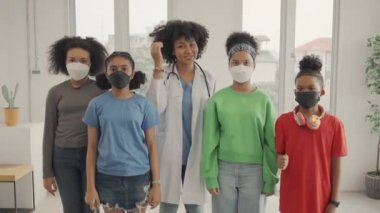 African American doctor and kids wearing mask  thumbs up finger in the hospital or clinic.