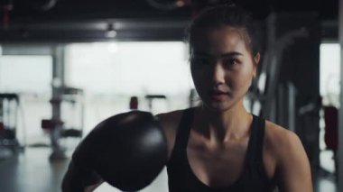 Female athletes practice kickboxing, practice boxing in the gym, enjoy a fitness lifestyle.