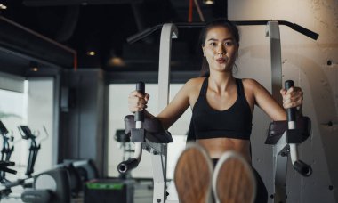 Sporty woman performing abdominal crunches training practicing in gym.