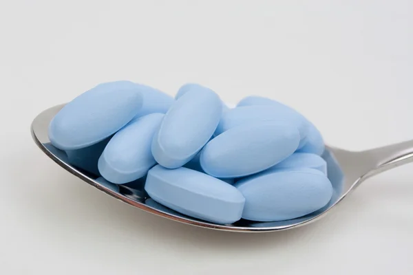 Loeffel mit blauen Tabletten — Stock Photo, Image
