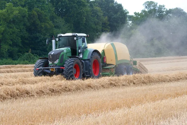 Tractor pressed bales of straw — Stock Photo, Image