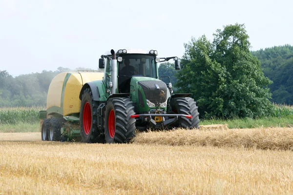 Tractor pressed bales of straw — Stock Photo, Image