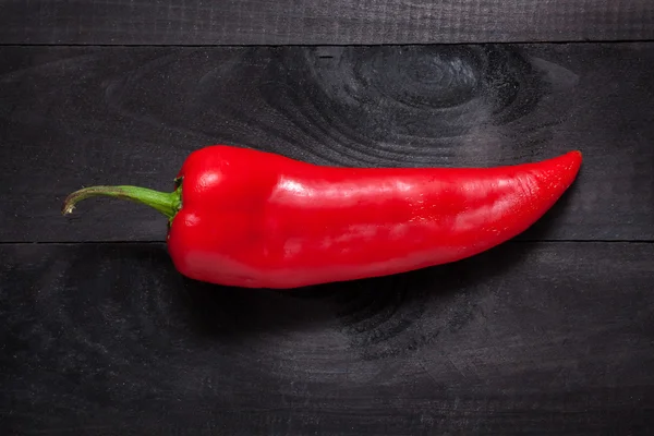 Red pepper on black — Stock Photo, Image
