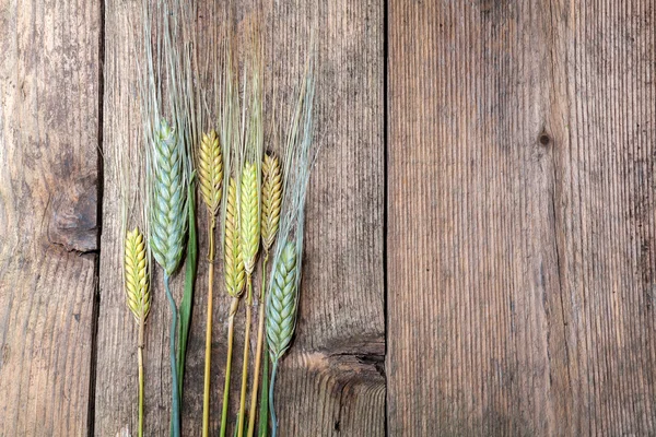 Wheat on wooden table — Stock Photo, Image