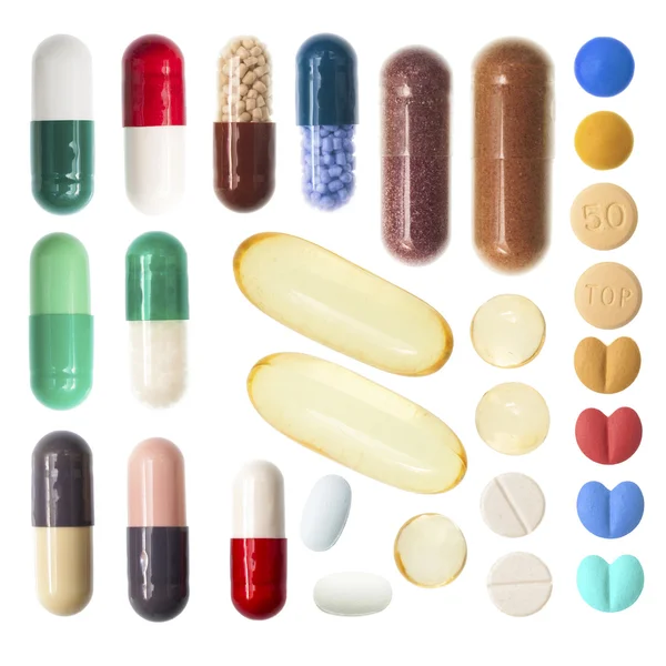 Pílulas e cápsulas em fundo branco — Fotografia de Stock