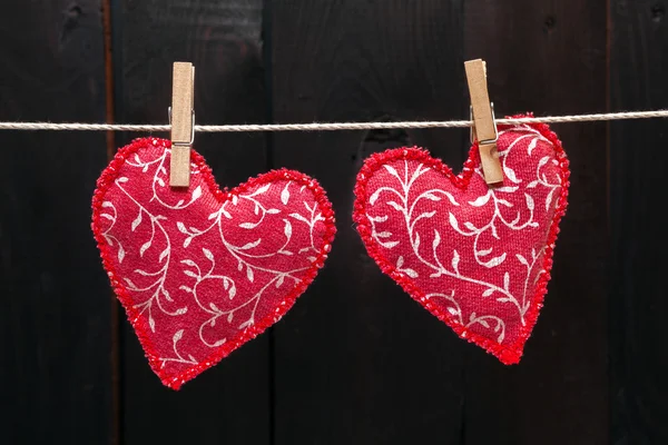 Röda hjärtan hänger på klädstreck — Stockfoto