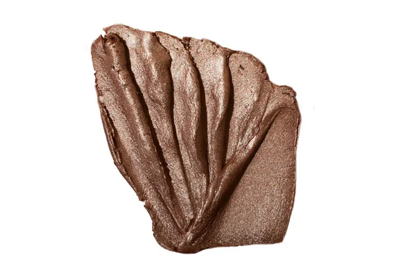 Kozmetik fosforlu kalemle parlatıcının makro fotoğrafı kabuk gibi görünüyor. Beyaz kumaş üzerinde izole edilmiş..