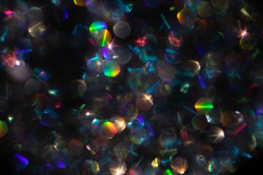 Abstract defocused black background with shining glitter.Good as overlay layer.