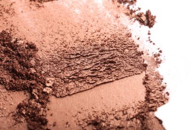 Crushed golden eyeshadow smear.Isolated on white.Professional cosmetics.Abstract cosmetics background.
