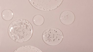 Background from cosmetic gel drops with bubbles.Top view,antibacterial liquid surface.Good as background or mockup,large banner.