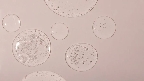 Background from cosmetic gel drops with bubbles.Top view,antibacterial liquid surface.Good as background or mockup,large banner.