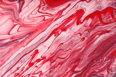Red monochrome liquid background from nail polishes.Negative space for text or design.