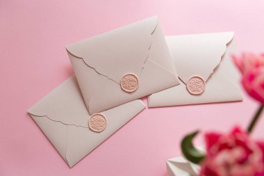 Photography from above of group of gift certificates.Tender pink color,banner with copy space.