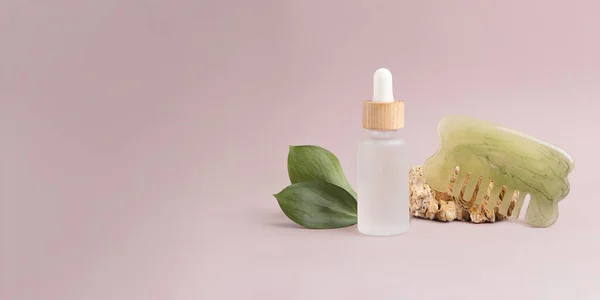 Eco friendly cosmetics oil dropper with hair brush near it.Concept of hair care.Large banner with negative space.