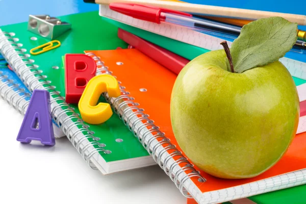 School supplies and green apple — Stock Photo, Image