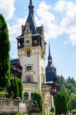Romanya 'nın Sinaia kentinde güneşli bir yaz gününde Bucegi Dağları (Muntii Bucegi) yakınlarındaki Peles Kalesi' nin (Castelul Peles) güzel neo-rönesans binası