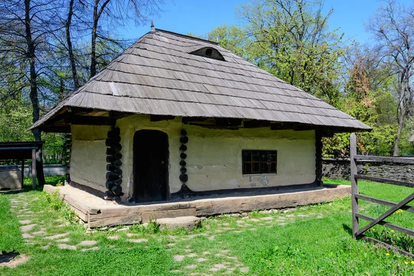 2021年4月25日ルーマニアのブカレスト 2021年4月25日 春の晴れた日に ヘラストラウ公園のディミトリ グスティ国立村博物館に古い木や緑の芝生に囲まれた古い伝統的なルーマニアの家 — ストック写真