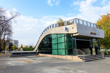 Bucharest, Romania, 6 November 2021: Main entry to Eroilor (Heroes) metro station near Romanian Opera and Dambovita river in the city center, in a sunny autumn day