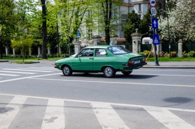 Bucharest, Romania, 24 April 2021 Old retro vivid green Romanian Dacia 1310 classic car in traffic in a street in a sunny spring day