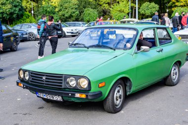 Bucharest, Romania, 24 October 2021: Old vivid green Romanian Dacia 1310 Sport classic car produced in year 1987 parked in a street in the city center, in a sunny autumn day