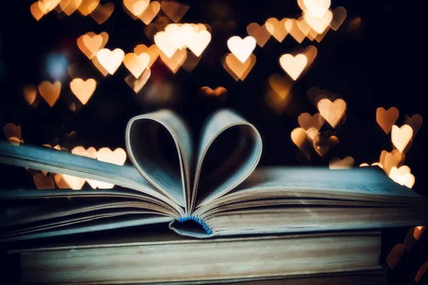 Bokeh kalplerinin arka planında kalp şeklinde bir kağıt kitap. Sevgililer Günü kavramı. Aşk sembolü. 
