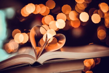 Heart from book pages love concept on heart bokeh background. VALENTİN GÜNÜ