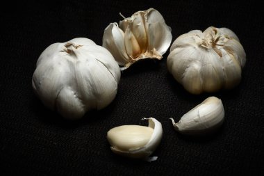 Karanlık bir arka planda baş ve sarımsak.