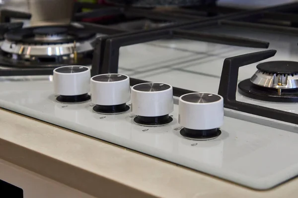 Close-up adjustment knobs. Gas stove with built-in controls.