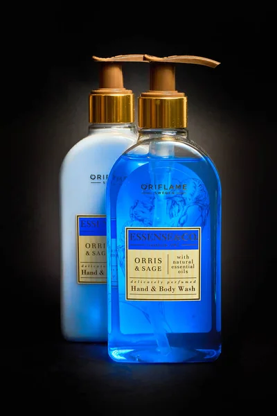 Ukraine - 01 10 2022: Liquid soap and lotion for hands and body with natural essential oils from the Oriflame company Sweden on a dark background, vertical shot