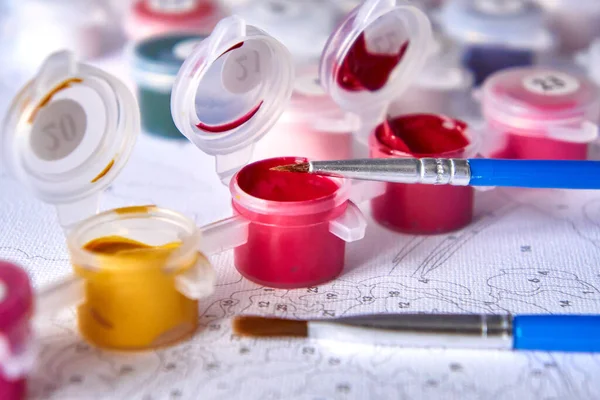 Resimler için suluboya boya kavanozlarını ve fırçaları arkaplandaki rakamlarla numaralandırın.