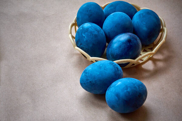 Blue painted eggs on a paper background.