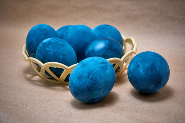 Blue painted eggs on a paper background.