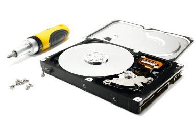Open hard drive and screwdriver isolated on white background closeup. Computer hard drive HDD. computer memory.