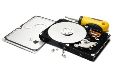 Open hard drive and screwdriver isolated on white background closeup. Computer hard drive HDD. computer memory.