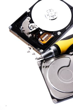 Open hard drive and screwdriver isolated on white background close up. Computer hard drive HDD. computer memory, vertical shot.