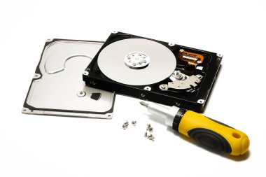 Open hard drive and screwdriver isolated on white background closeup. Computer hard drive HDD. computer memory.