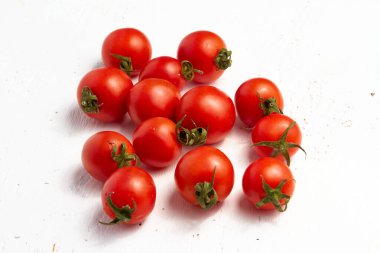 Cherry tomato group, ripe organic tomatoes on a light background.
