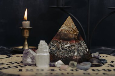 Mystic ritual with Ouija and candles. Devils board concept, black magic or fortune telling rite with occult and esoteric symbols. Mystical rituals and occult sciences.