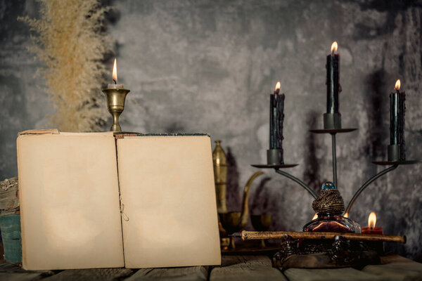 Vintage wallpaper with copy space. Antique desk with inkwell and pen writing a book on a blueprint.