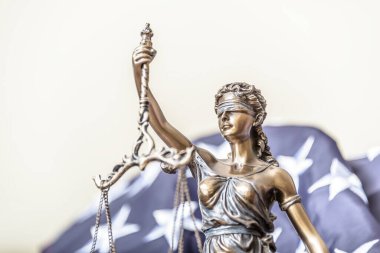 Themis 'in bronz heykelciği ön planda olmak üzere evlilik yüzüklerini denge terazisinde tutuyor. Çift boşanması