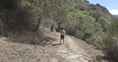 Caucasian boy of 7 years walks through the Pyrenees cross country