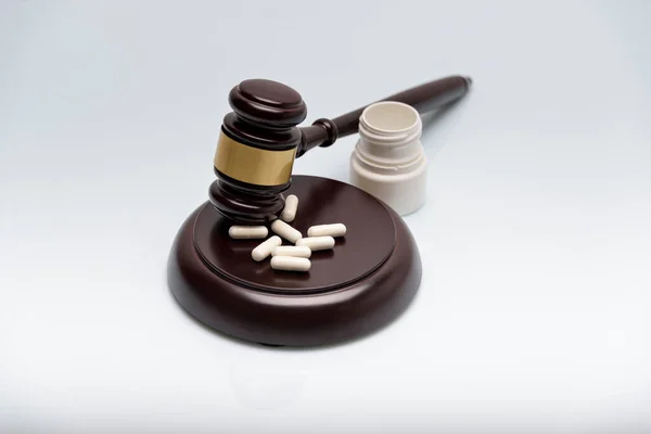 Medicine law concept. Gavel, stethoscope and pills isolated on white