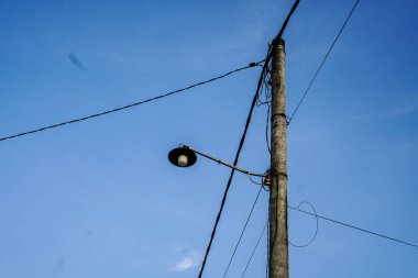 Kablo yapısı ve mavi gökyüzü olan sokak lambası direği