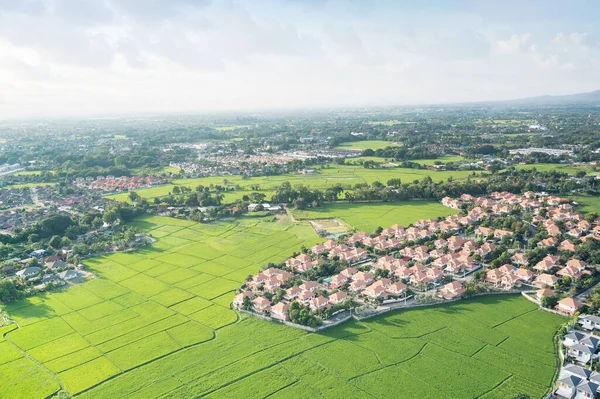Land or landscape of green field in aerial view. Include agriculture farm, house building, village. That real estate or property. Plot of land for housing subdivision, development, sale or investment.